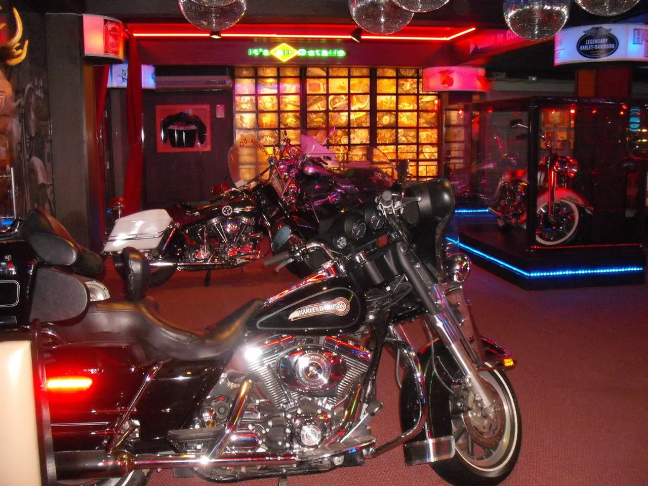 In this picture we can see few motorcycles, lights and hoardings.