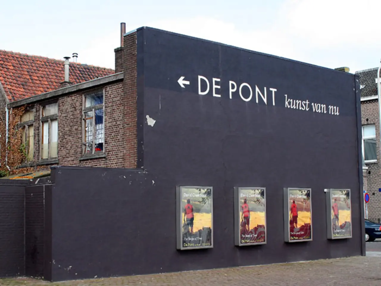 In this image we can see four boards are fixed to the black color wall and here we can see some...