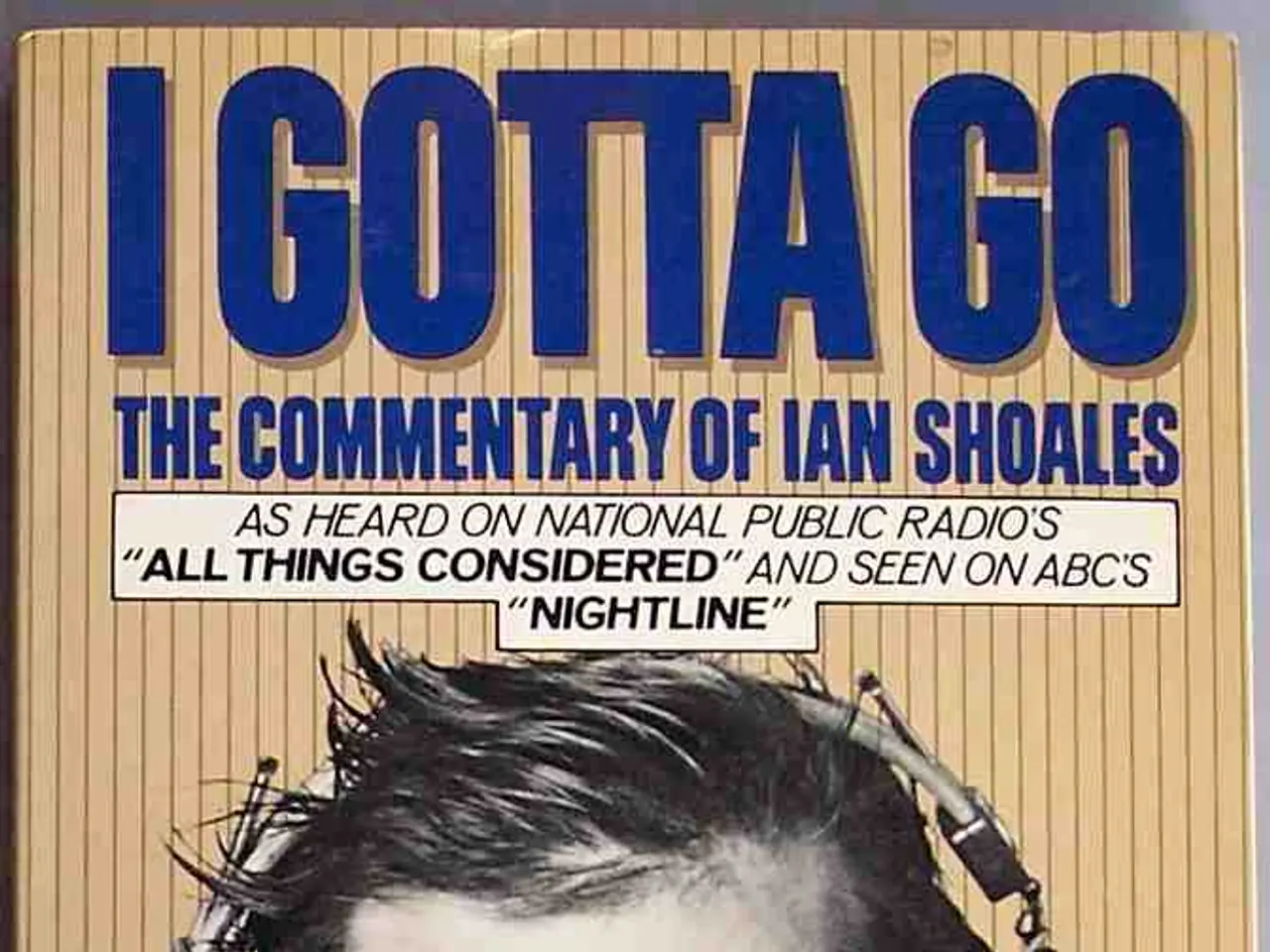 In the picture I can see the poster. On the poster I can see a man wearing a suit and a tie and...