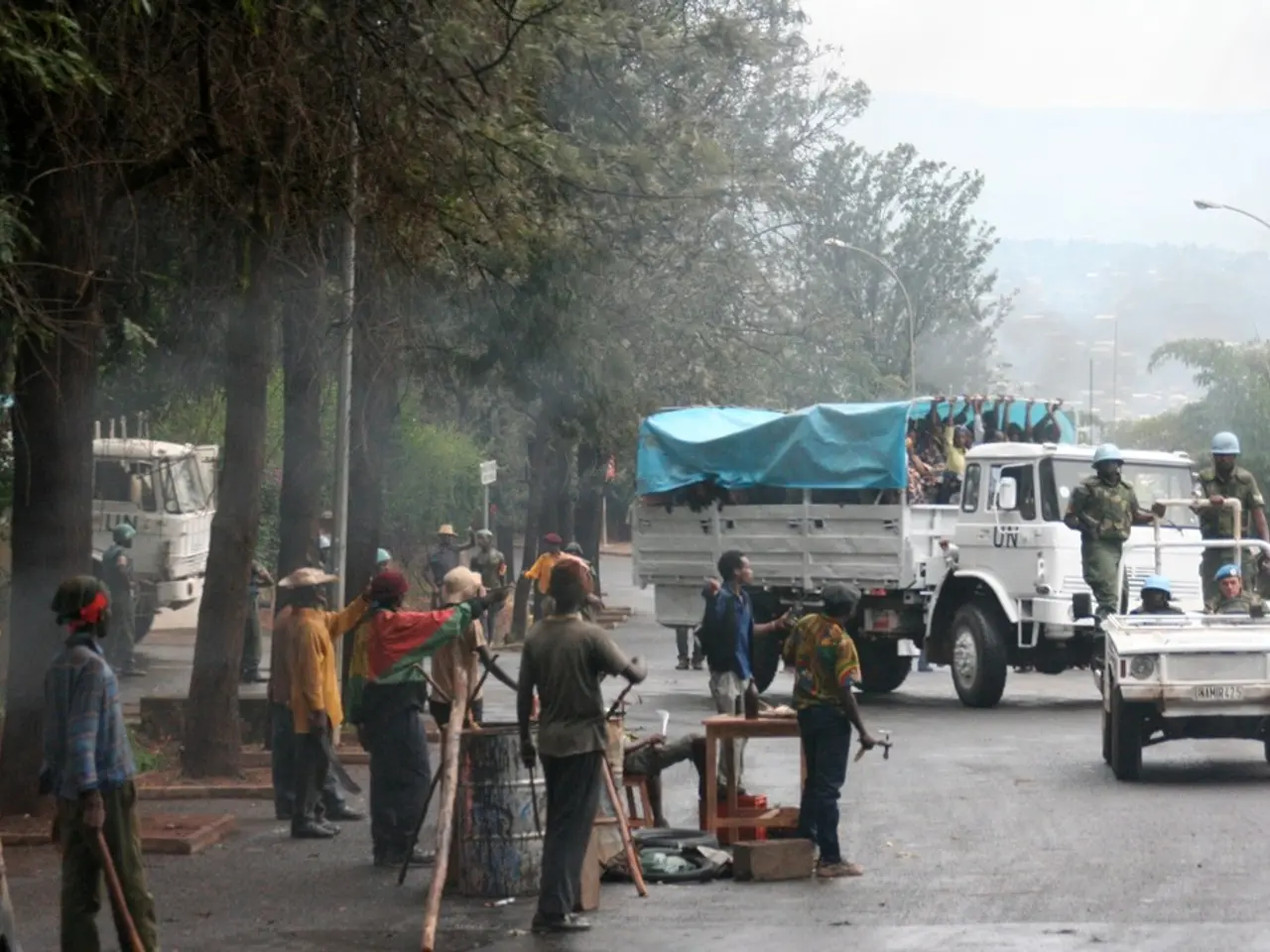In the picture there are many workers and they are doing some work beside the road and there is a...