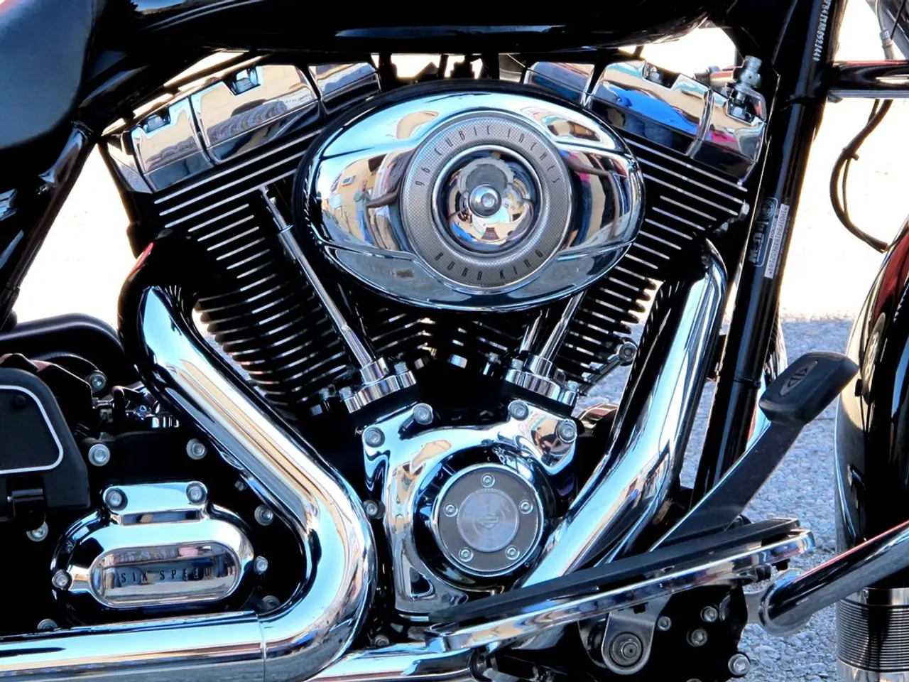 In the image there is a motorcycle parts with engine, radiator, exhaust pipe, gear, rods, nuts and...