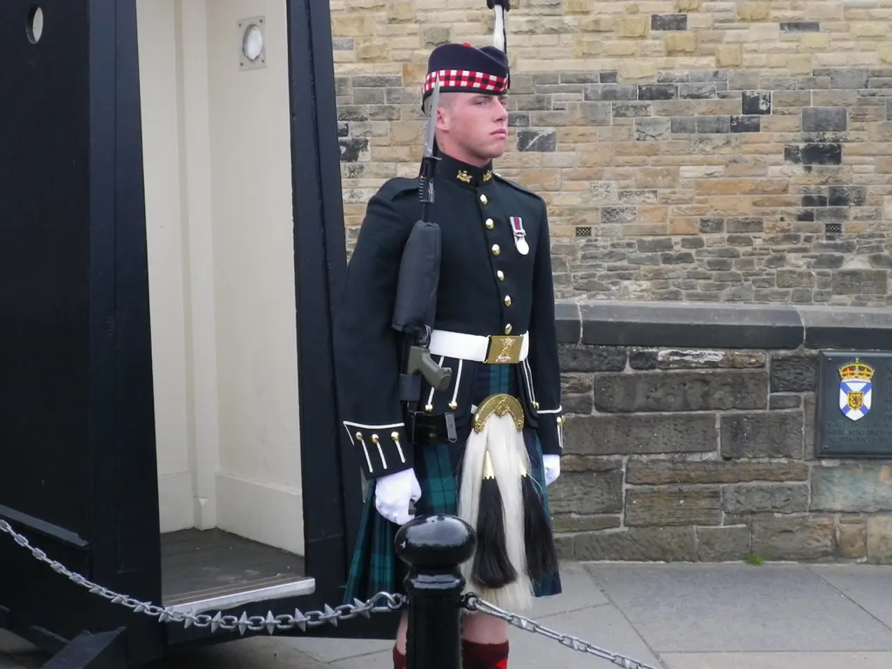 In this image there is one person standing in the middle of this image is holding a gun. There is a...