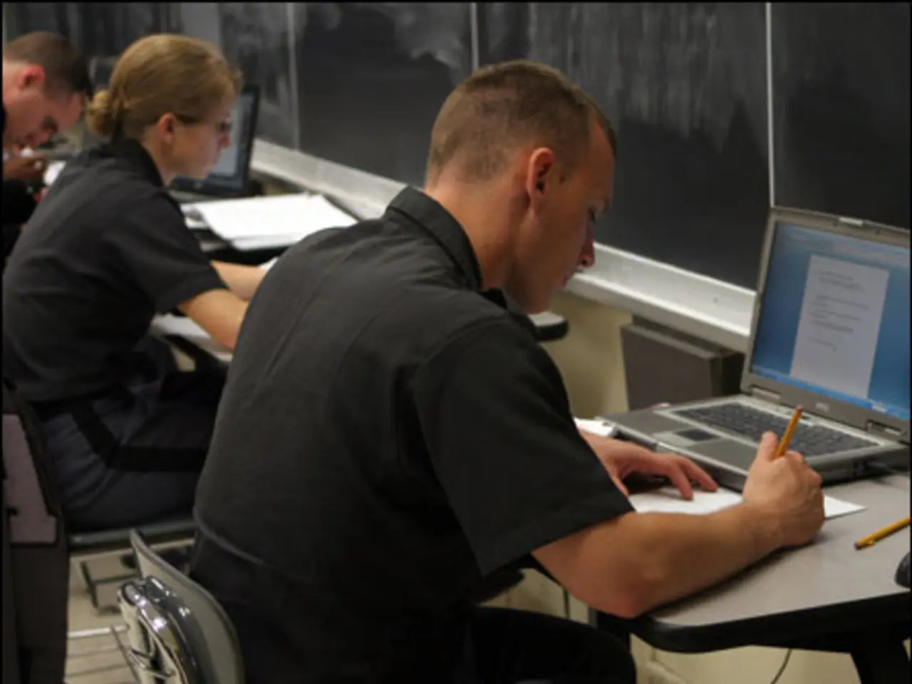 In the picture we can see two men and a woman sitting on the chairs near the desk and they are...