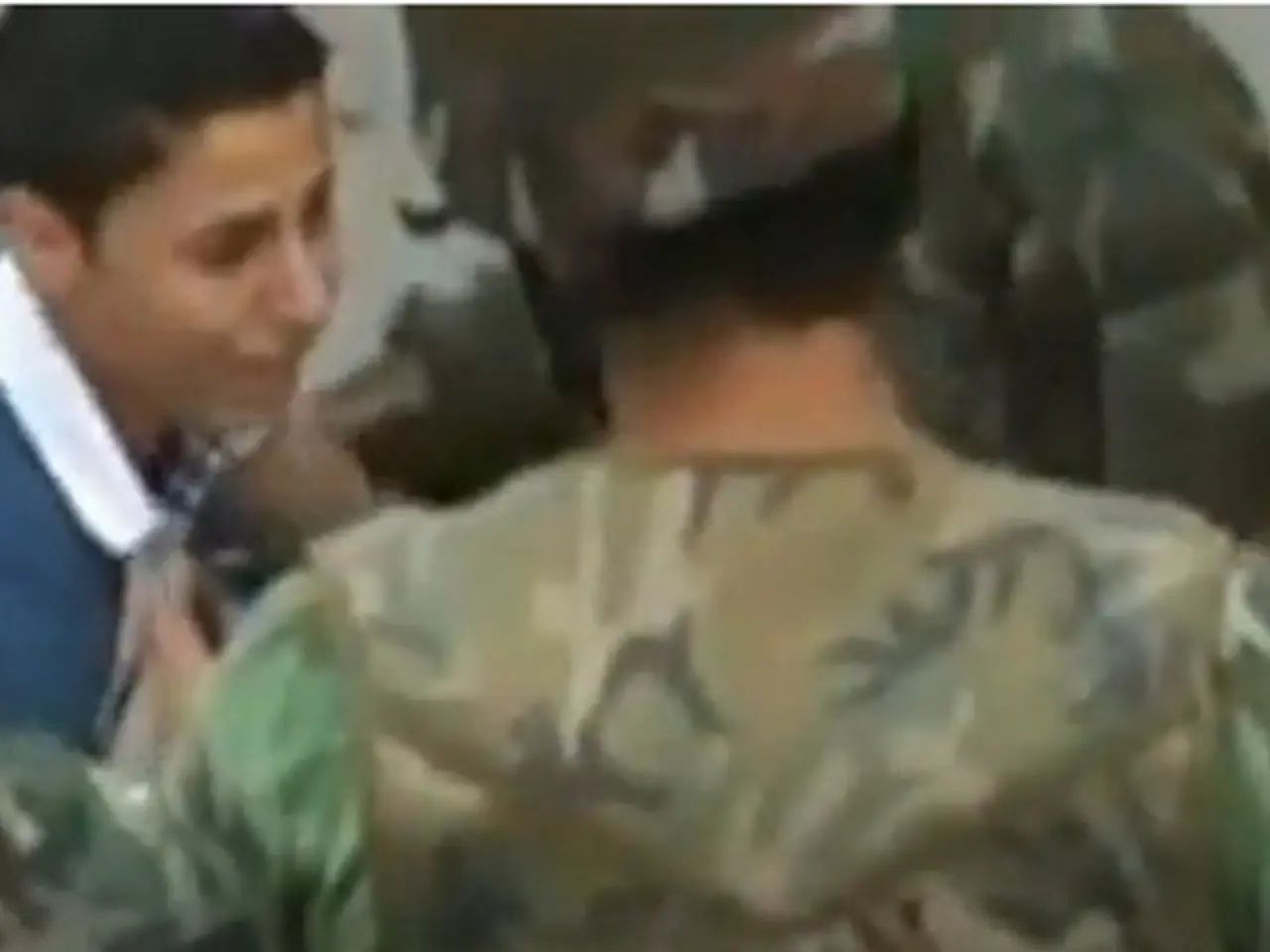 In this image there is a military officer in the middle who is holding the gun. In front of him...