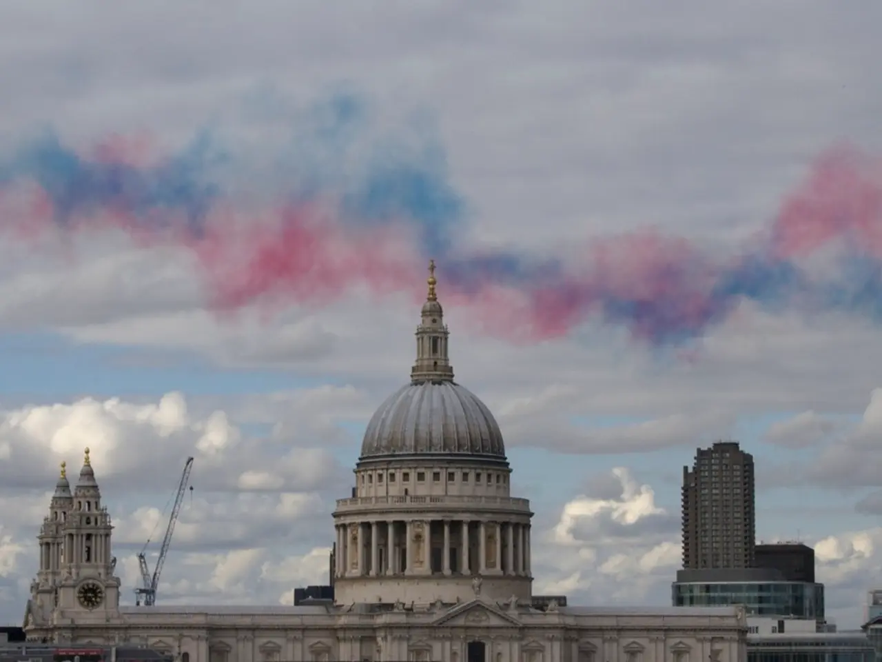 This picture shows few buildings and we see a clock on the tower of the building and we see a crane...