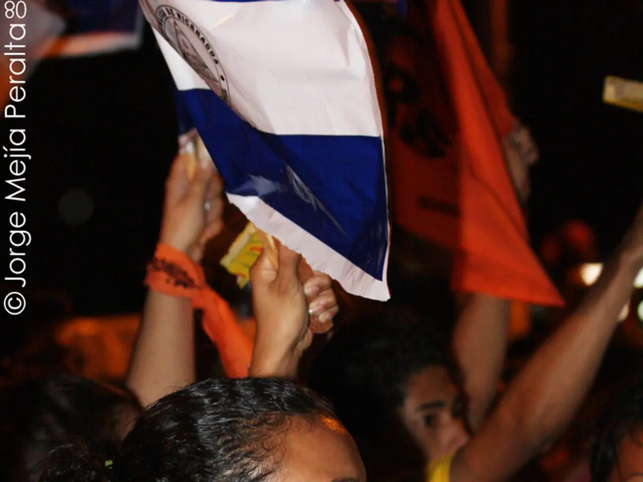 In this picture we can see the women wearing green t-shirt standing in the protest and holding the...