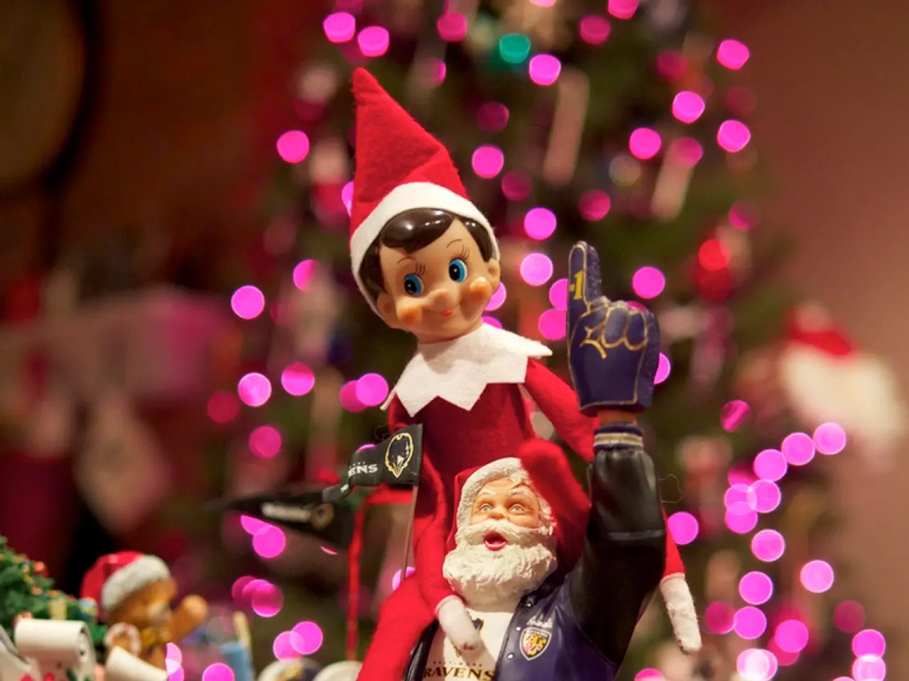 In the foreground of the image there are toys. In the background of the image there is a Christmas...