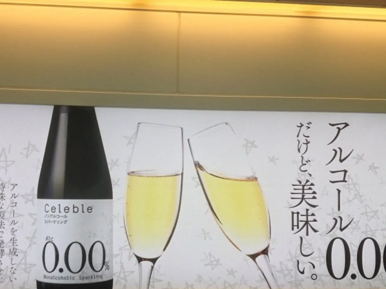In this picture we can see a poster, on this poster we can see a bottle and glasses with drink in...