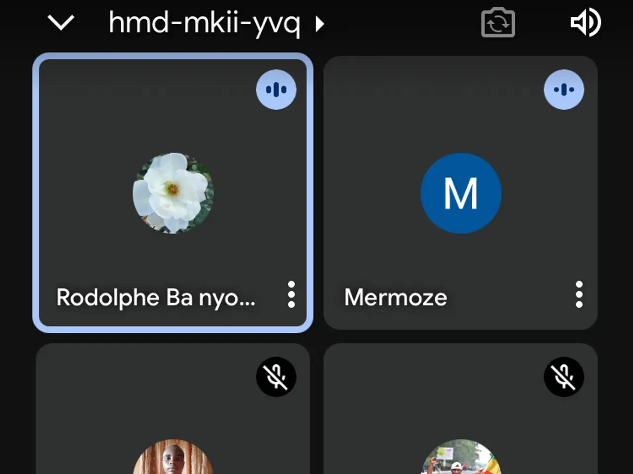 The image shows a screenshot of a cell phone with a group of people on the screen, along with text...