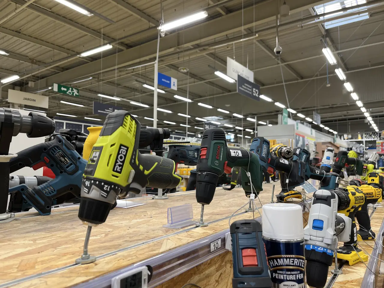 The image shows a store filled with lots of different types of power tools on display, including...