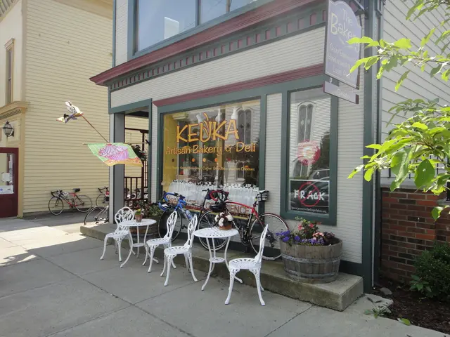 The image is outside of the city and it is very sunny. On right side we can see few tables and...