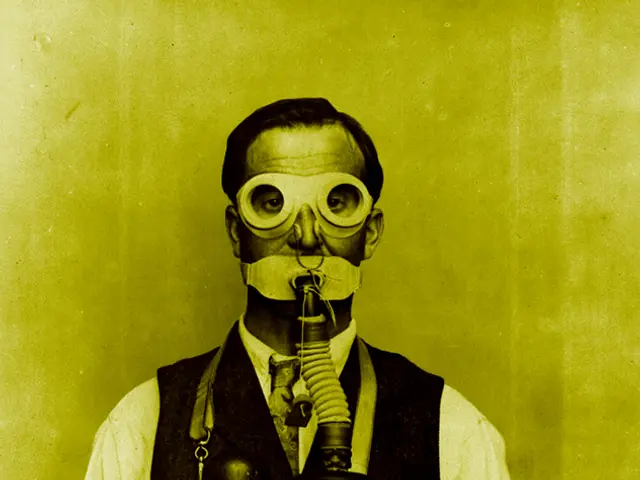 In this picture there is a man wearing oxygen cylinder, behind him it is green.