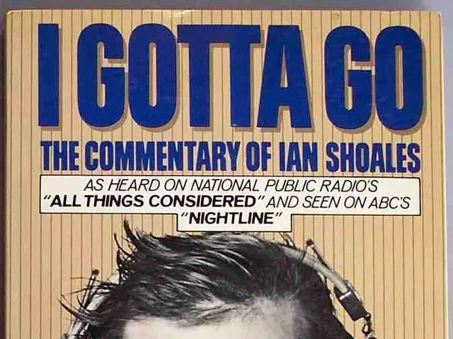 In the picture I can see the poster. On the poster I can see a man wearing a suit and a tie and...