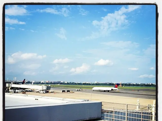 In this picture we can see a fence, and a container, in the background we can see few vehicles, and...