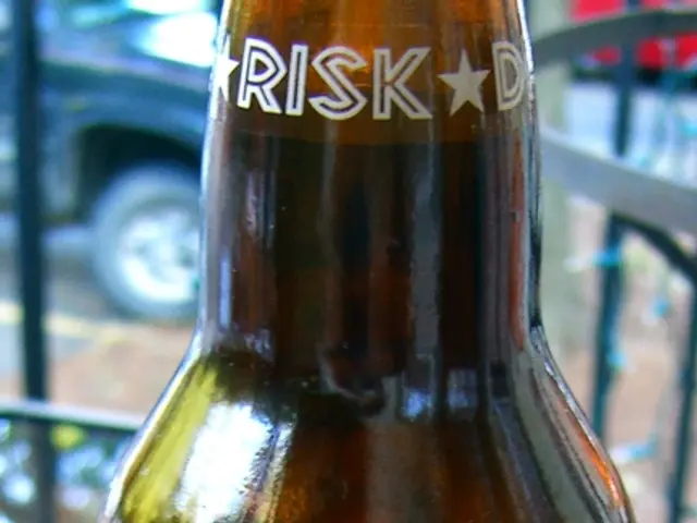 In this picture there is a bottle of cool drink and RISK word is written at the top of the bottle...
