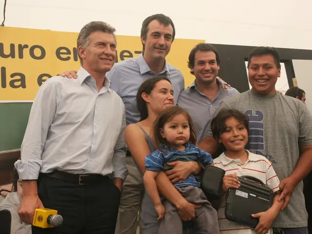 In this picture we can see six persons are standing and smiling, a woman in the front is carrying a...