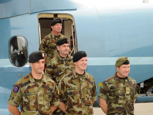 This picture describes about group of people, they wore caps, behind them we can see a plane.