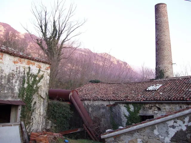 As we can see in the image there are buildings, plants, trees, hills and sky.