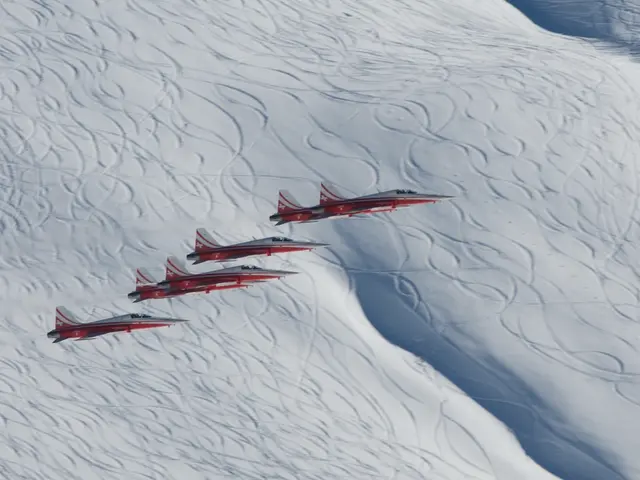 In this picture there are aircrafts flying. At the bottom it looks like snow and the aircraft's are...