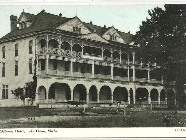 This is a black and white photo, where there is grass, plants, building, trees, sky and a watermark...