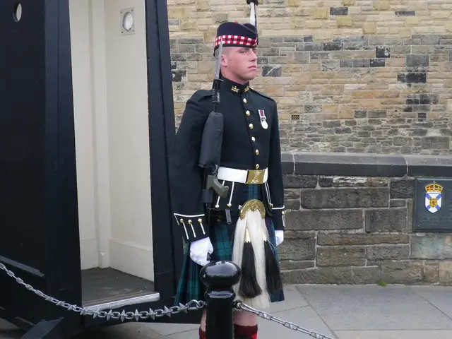 In this image there is one person standing in the middle of this image is holding a gun. There is a...