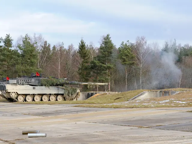 In this picture, we can see a few military tankers, we can see the ground with some objects, grass,...