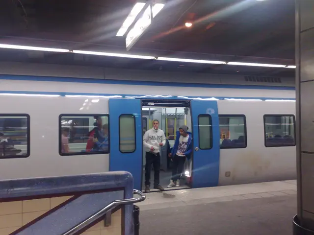 This is the picture of a railway station. In this image there is a train on the railway track and...