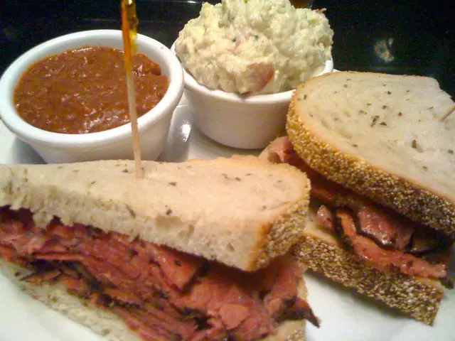 In this image we can see a serving plate which has stuffed sandwiches and two bowls of dips in...