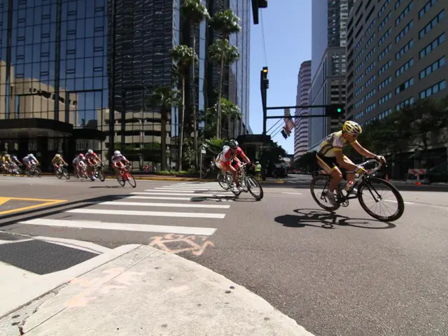 This image consists of many people riding bicycles. At the bottom, there is a road. On the left and...