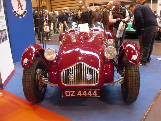 In the image there is a vehicle kept for an expo and on the left side there are two banners, around...