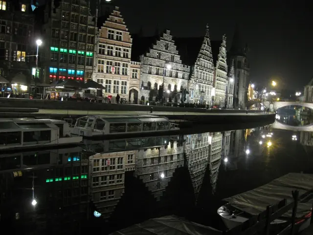 In this picture there is a small water pond and two white color boat are standing. Behind there are...