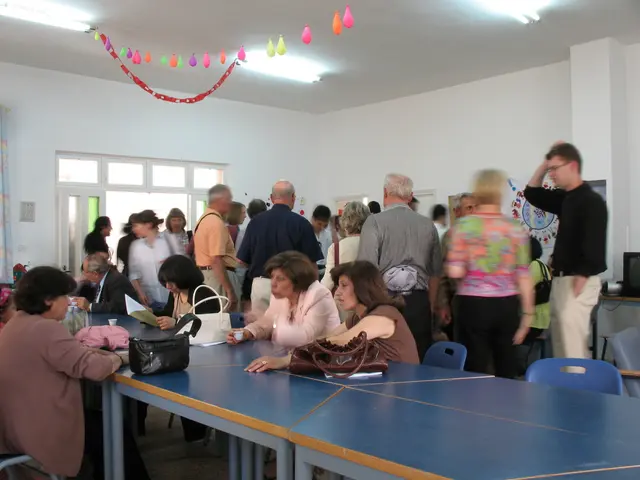 This is the picture of a room where we have some people sitting on the chair in front of the table...