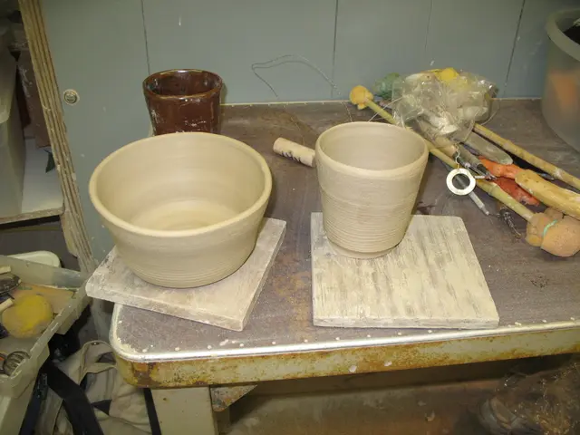 In this image there is a table on which we can see there are some bowls kept on wooden pieces...