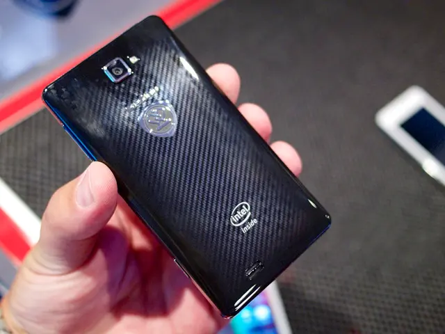 In this image we can see a person holding a mobile phone. And we can see the human hands.