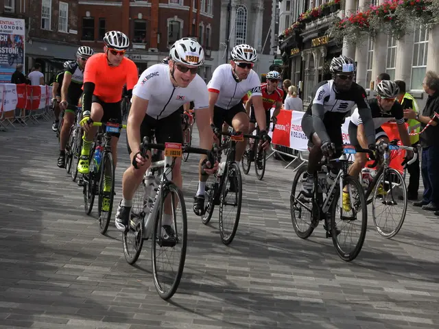 In the image there are few men with helmets and goggles. They are riding bicycles. Behind them...