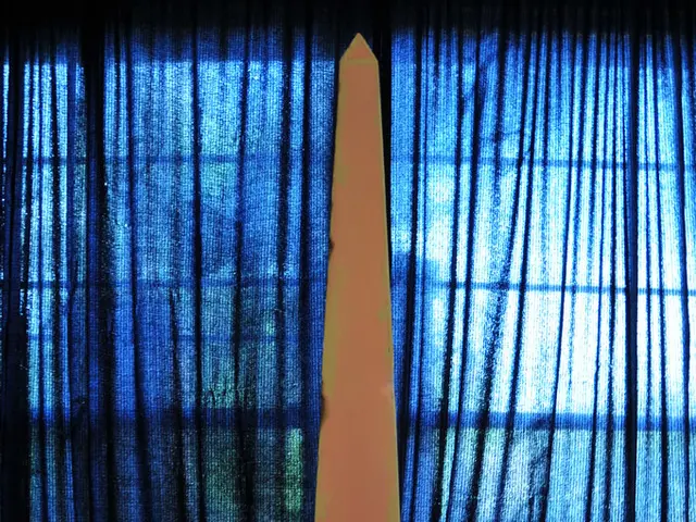 In this image we can see a pillar on a stand. On that something is written. In the back there is a...