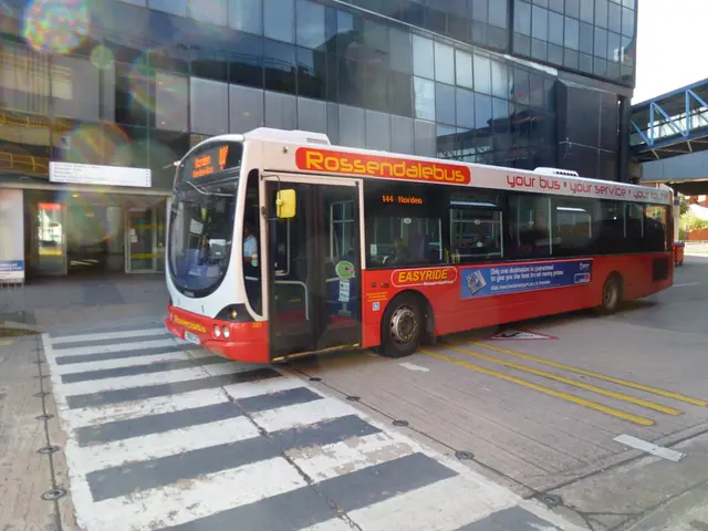 In this picture we can see a bus on the road, and few people are seated in it, in the background we...