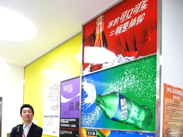 In this picture I can see there is a man standing and he is wearing a blazer and on to right there...