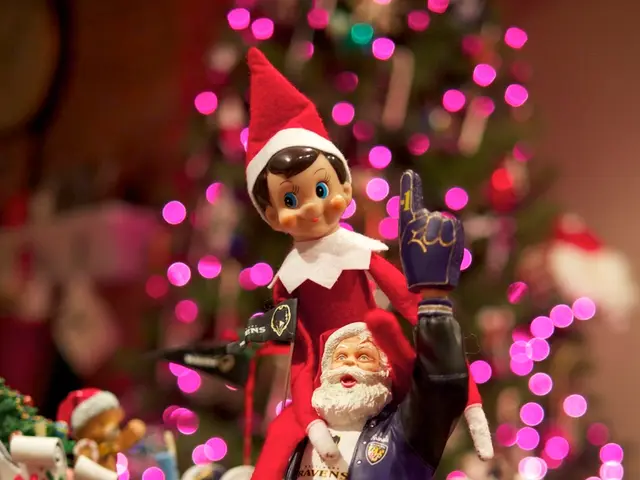 In the foreground of the image there are toys. In the background of the image there is a Christmas...