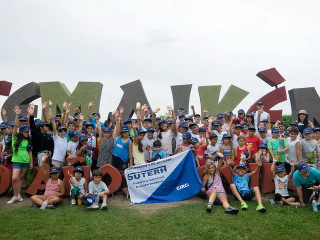 This is an outside view. Here I can see few children are standing, raising their hands up and...