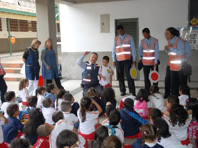 In this image we can see there are few kids sitting on the floor, in front of them there are a few...