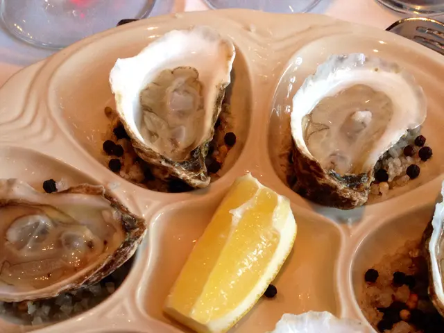 In this picture we can see six Chilean oyster in the plate. In the center we can see the lemon...