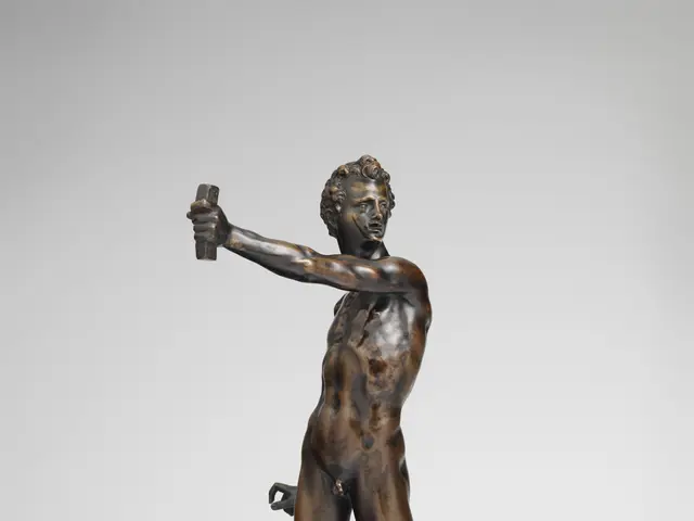 The image shows a bronze sculpture of a man holding a bird in his hand, set against a white...