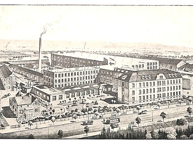 The image shows an aerial view of a large factory with many buildings, trees, vehicles on the road,...