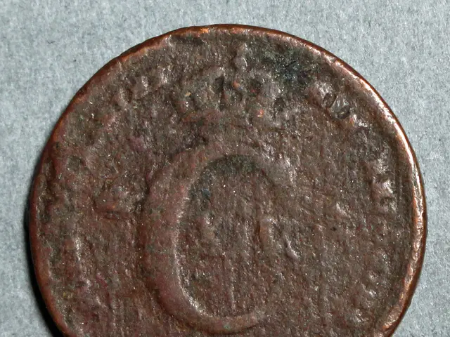 The image shows a copper coin with the letter 'C' on it resting on a grey surface.
