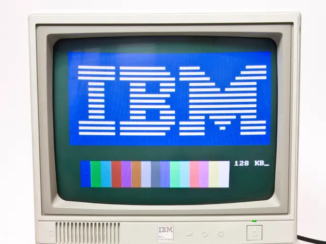 The image shows an old IBM computer with a blue screen and a keyboard, set against a white...