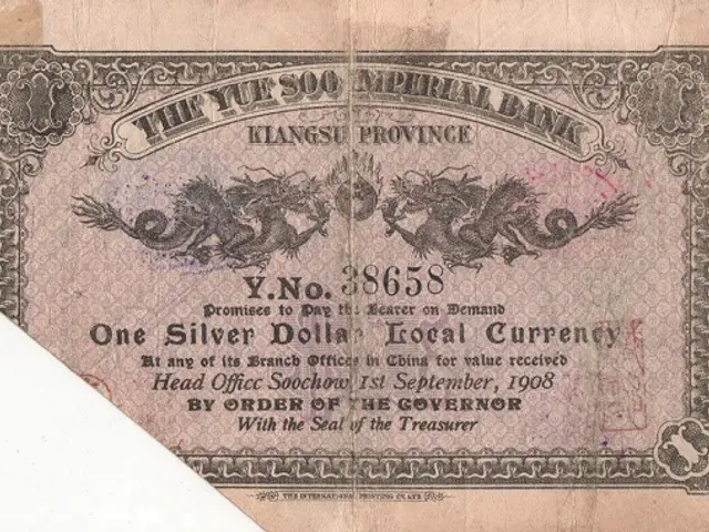 The image shows an old Chinese banknote with a dragon on it. The paper has text and numbers written...