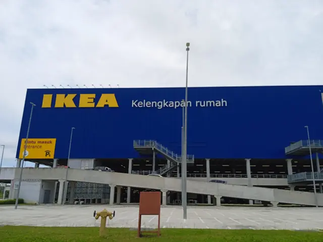 The image shows an IKEA store in Jakarta, Indonesia, with a fire hydrant in front of it. The ground...