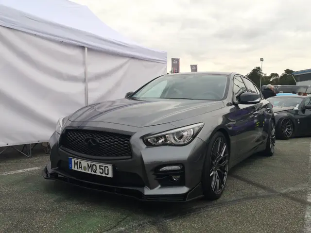 The image shows an Infiniti Q50 Red Sport 400 at the Goodwood Festival of Speed. There are several...