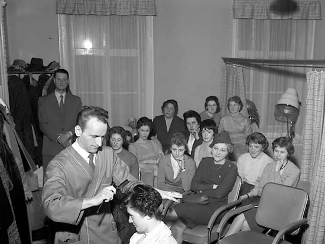 The image shows a black and white photo of a woman getting her hair done in a salon. There are many...